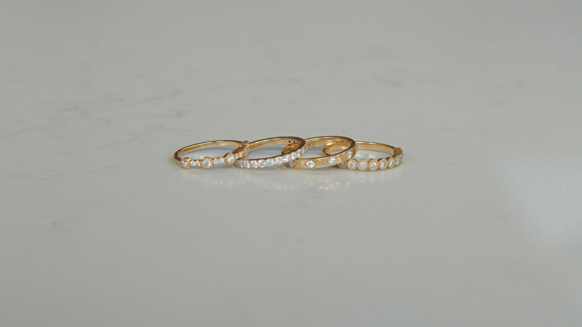 Set of four 18K gold labgrown diamond rings by Juna Fae, designed as stackable bands perfect for wedding rings or everyday rings to celebrate life’s special moments, all created in Antwerp with an ethical and sustainable production. 