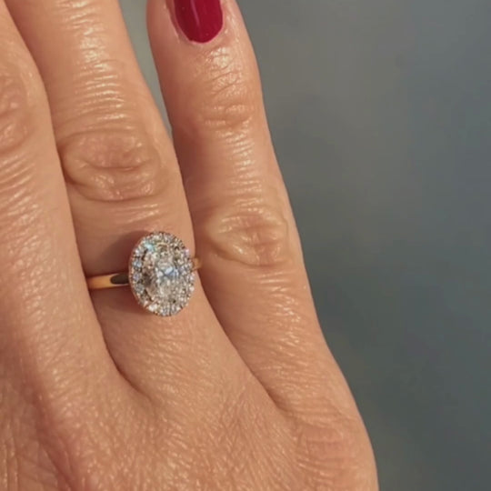 Video of the Dahlia Ring worn on the hand, an oval lab-grown diamond in a diamond halo, recycled 18K gold