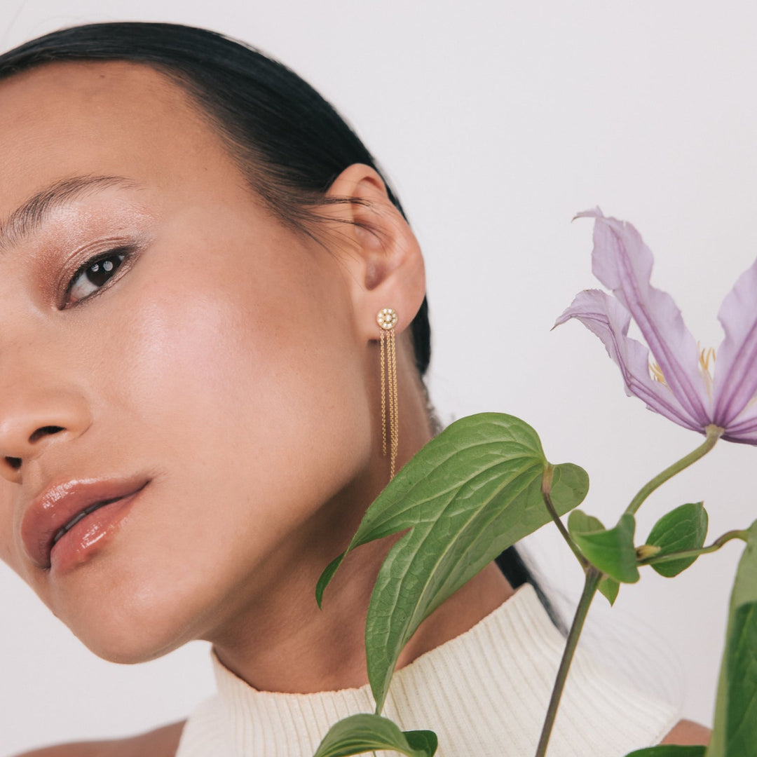 Violet diamond stud earring styled with a chain add-on in recycled 18K yellow gold