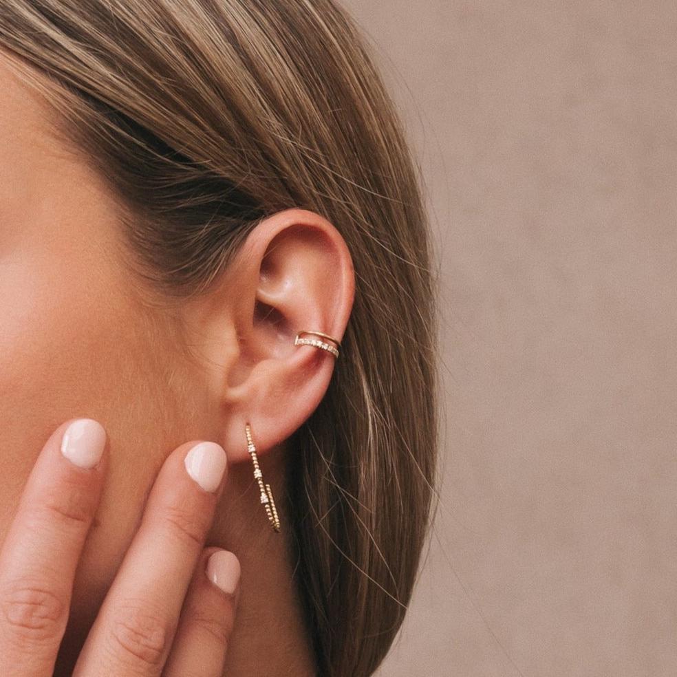 Model wearing the Camellia Ear Cuff with a chain earring