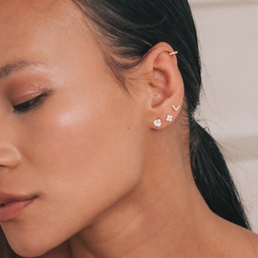 Model wearing the Avery Stud in a curated ear stack of diamond studs
